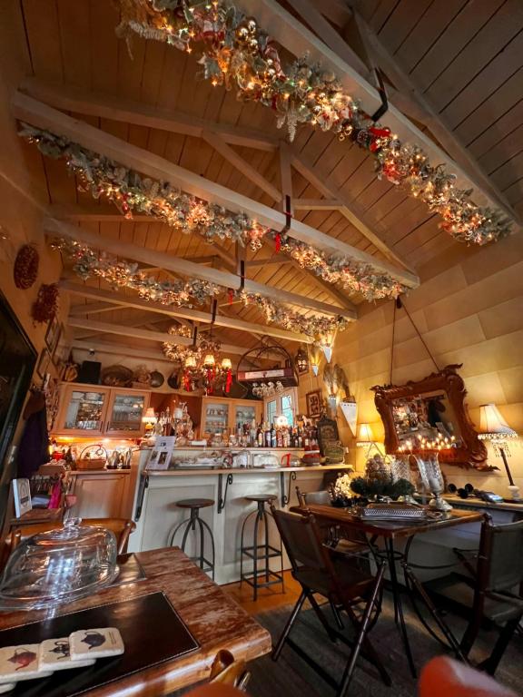 bar z lampkami świątecznymi, stołami i krzesłami w obiekcie Anerada inn Suites & Spa - Pet Friendly w mieście Karpenision