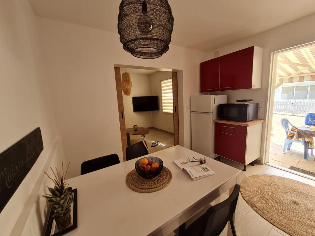 a kitchen with a table with a bowl of fruit on it at ELLE Loc St-Brévin in Saint-Brevin-les-Pins