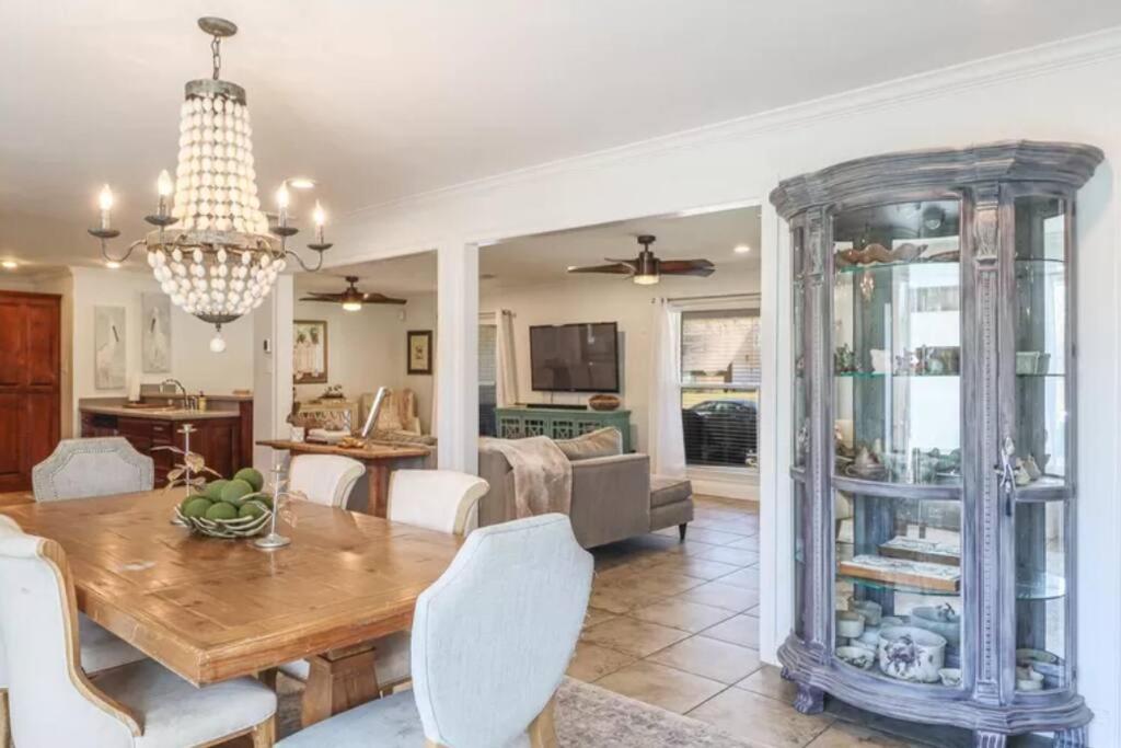 a dining room and living room with a table and chairs at 4/3 Home Centrally Located, beach, casino, airport, dining, golfing, shopping, entertainment in Gulfport
