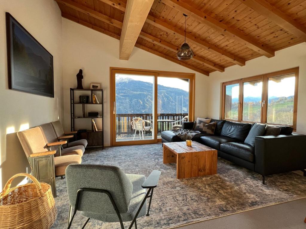 a living room with a couch and a table at Casa Campanula in Laax