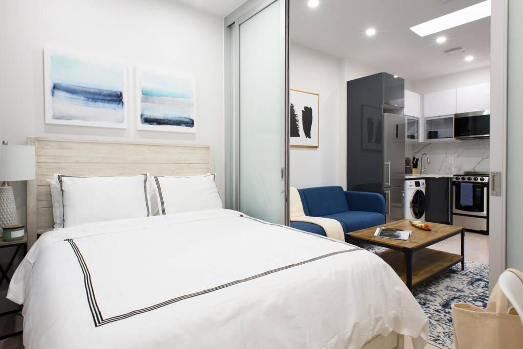 1 dormitorio con 1 cama blanca grande y sala de estar en 78-4B NEW Quality 1br W&D in unit SKYLIGHTS, en Nueva York