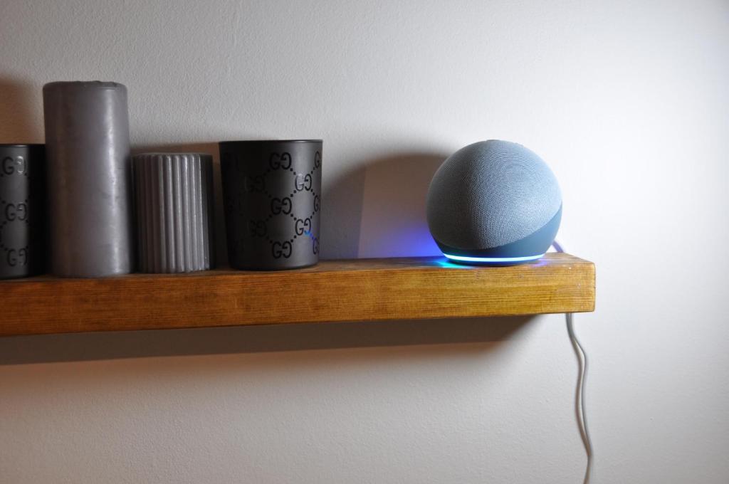 a wooden shelf with a speaker and cups on it at C Studio - Design Bilo Suite -M3- 8 min dal Duomo in Milan