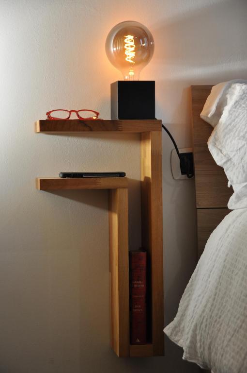 a table with a lamp on it next to a bed at C Studio - Design Bilo Suite -M3- 8 min dal Duomo in Milan