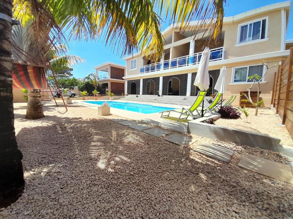 a villa with a swimming pool and a house at Villa Paprika in Trou aux Biches