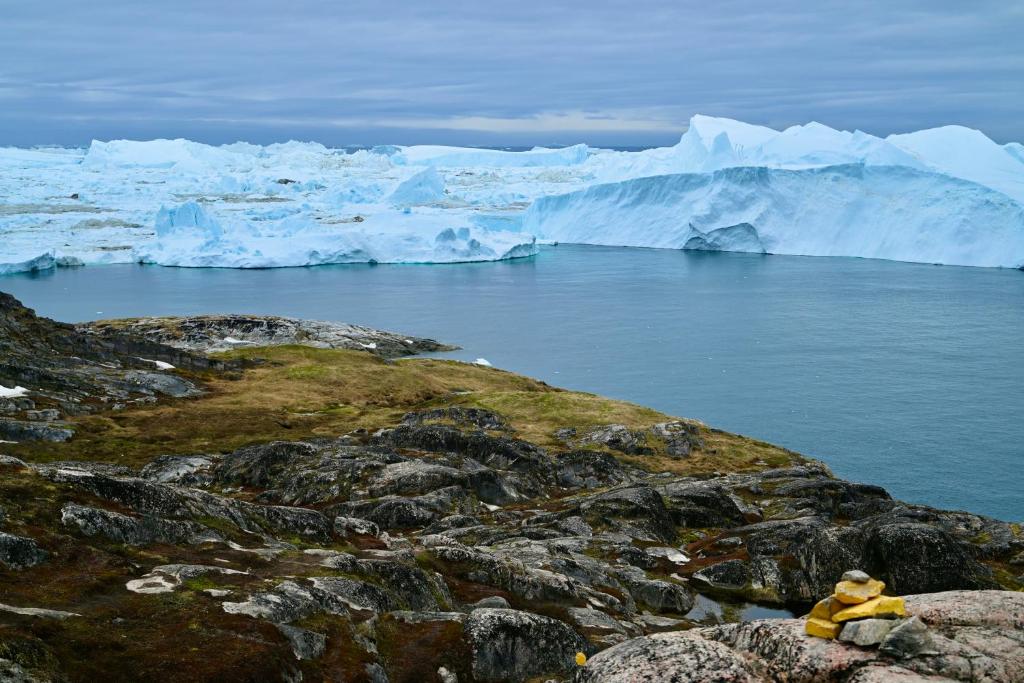 a group of icebergs in a body of water at Hotel Hvide Falk in Ilulissat