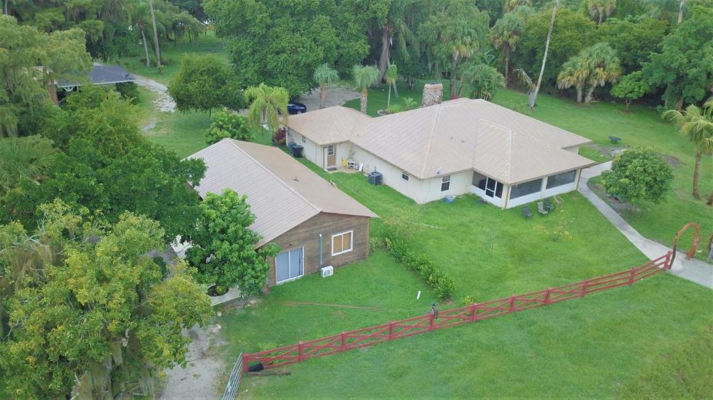 an aerial view of a house with a yard at Beautiful Vacation Home Across From Lake Okeechobee in Okeechobee