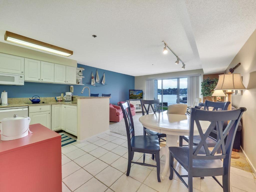 a kitchen and dining room with a table and chairs at 117D Edgewater Inn in Charlevoix