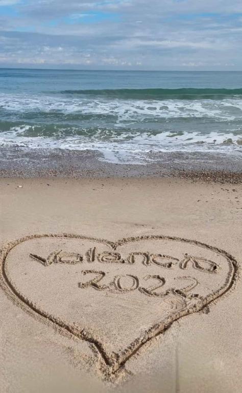a heart drawn in the sand on the beach at Salamar Saler Golf in El Saler