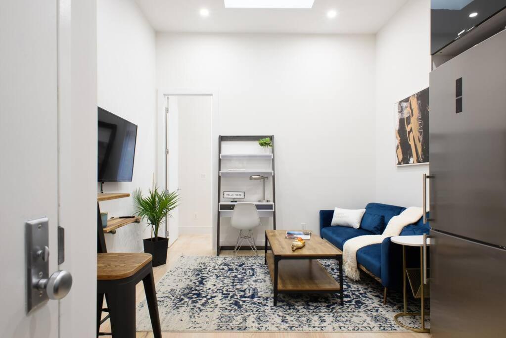 a living room with a blue couch and a table at 78-4D Quality 1br W&D SKYLIGHT By Central Park in New York