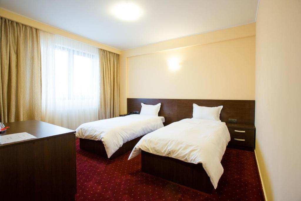 Postel nebo postele na pokoji v ubytování Hotel Athos
