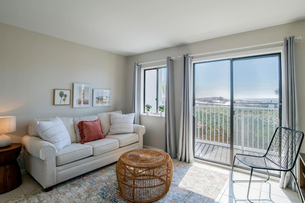 a living room with a couch and a large window at Beachfront Stylish Condo - Stunning Views! in Gulf Shores