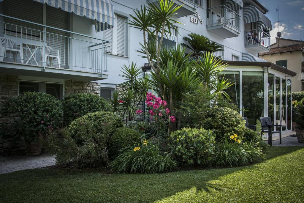 a garden in front of a building with flowers and plants at Hotel Riviera Blu in Tirrenia
