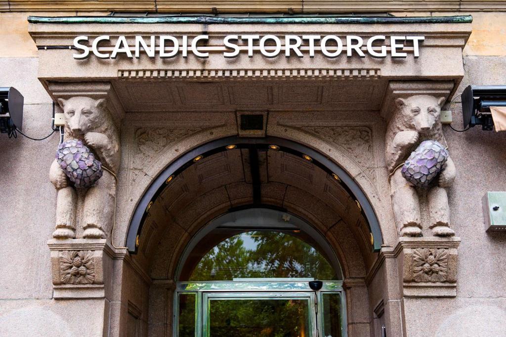 una entrada a una sinagoga con dos estatuas de animales sobre una puerta en Scandic Stortorget, en Malmö