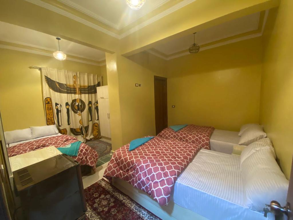 Postel nebo postele na pokoji v ubytování Bella Casa Pyramids Inn