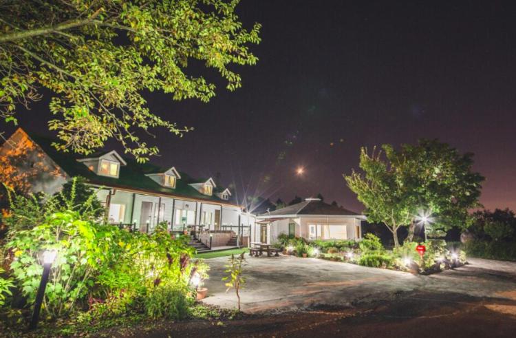 a house with lights in front of it at night at Sunyang Village Dome Caravan in Jeju