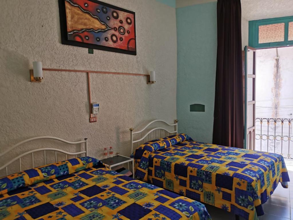 Postel nebo postele na pokoji v ubytování HOTEL LIMÓN