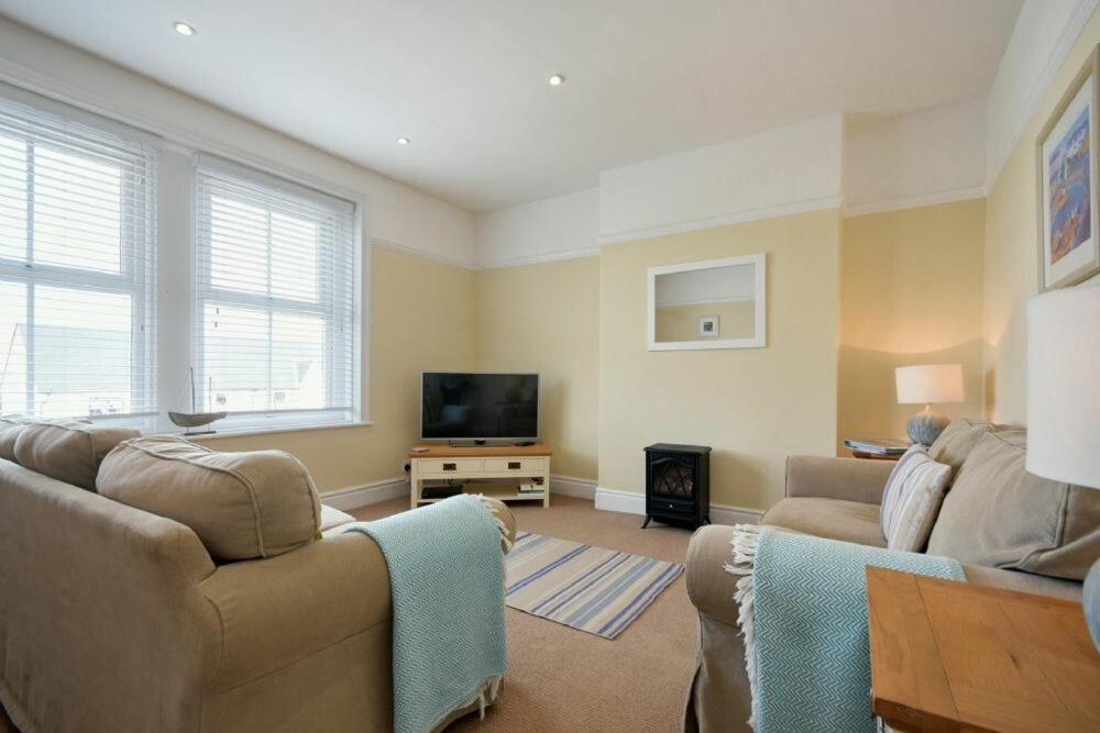 a living room with a couch and a flat screen tv at Coastal Haven in Seahouses