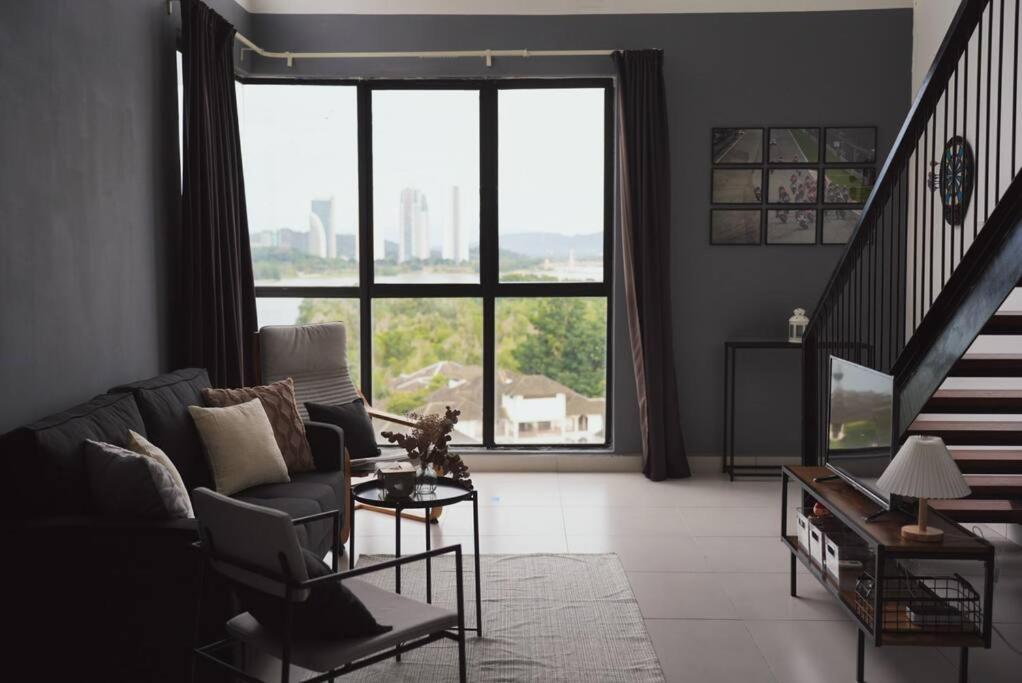 a living room with a couch and a large window at Loft Style Duplex w/ Ultimate lakeview @ Sawtelle in Cyberjaya