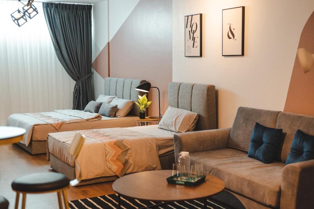 a living room with two beds and a couch at SUMMER SUITES APARTMENT-The Summer Shopping Mall in Kota Samarahan