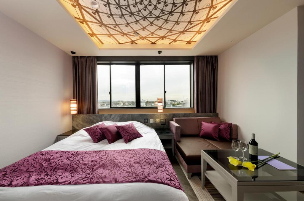 Postel nebo postele na pokoji v ubytování Hotel Cocoon -Urban Luxury-