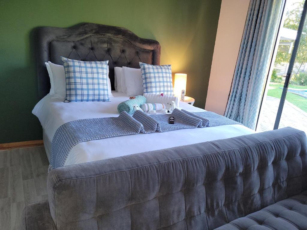 a bedroom with a large bed with two stuffed animals on it at Ayana bnb in Bloemfontein
