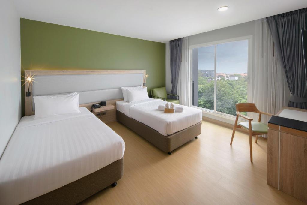 Postel nebo postele na pokoji v ubytování Prime Square Hotel