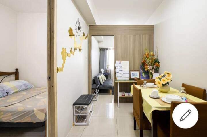 a room with a bed and a table and a bedroom at Paranaque SM-Sucat Field Res. Bldg 5, 2/F, 2BR with Balcony in Manila