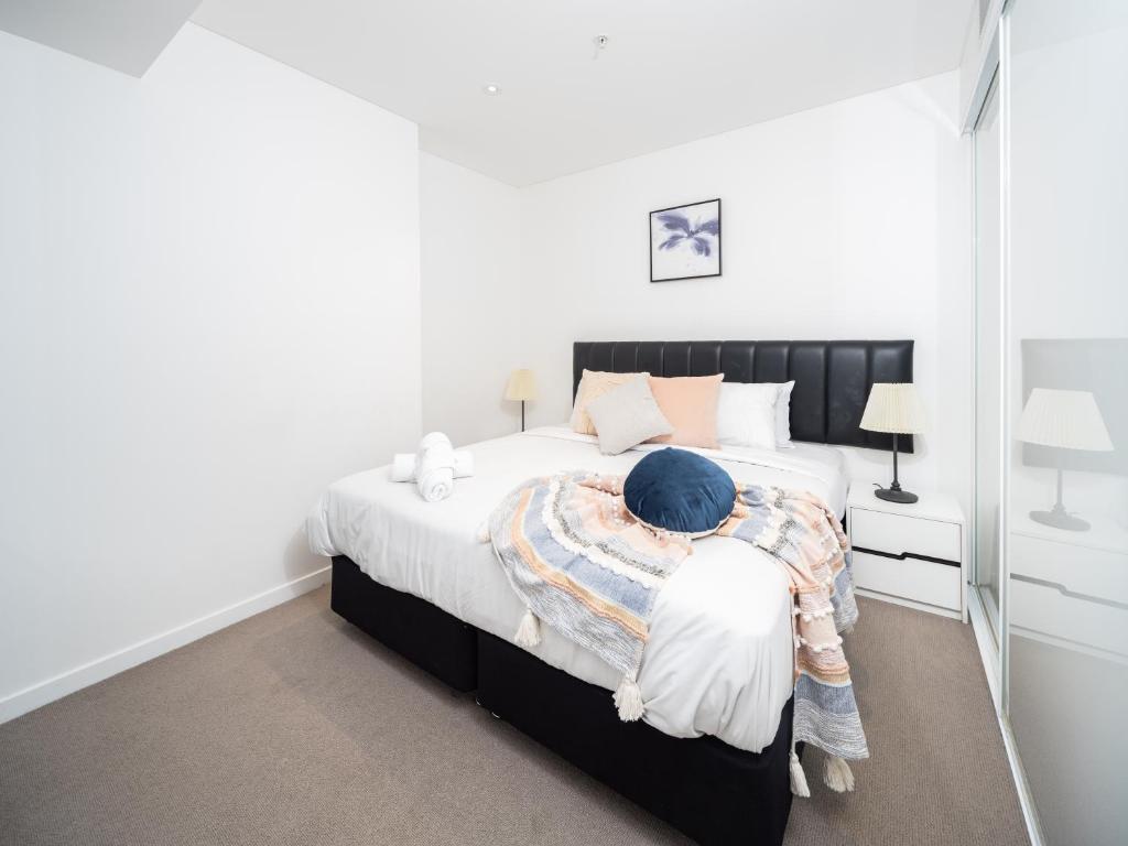 a bedroom with a large bed with a black headboard at Lvl 24 Family apartment in the heart of CBD by Stylish Stays in Brisbane