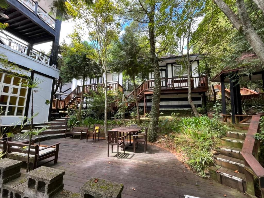 a patio with a table and chairs and a house at Naluwan Villa in Ren&#39;ai