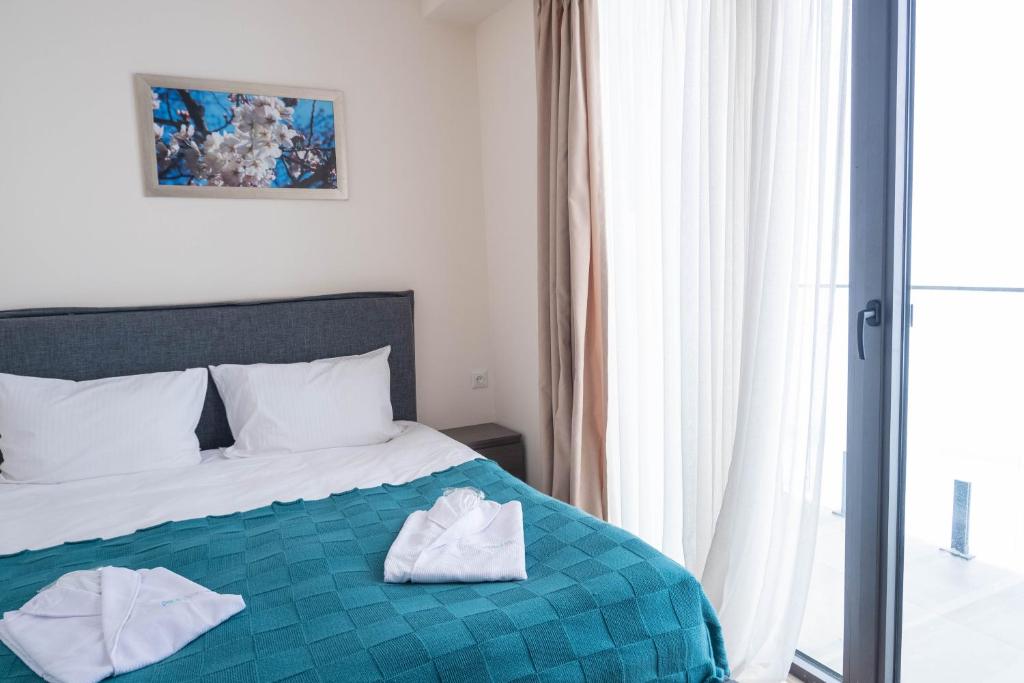 Postel nebo postele na pokoji v ubytování New Gudauri Atrium 211