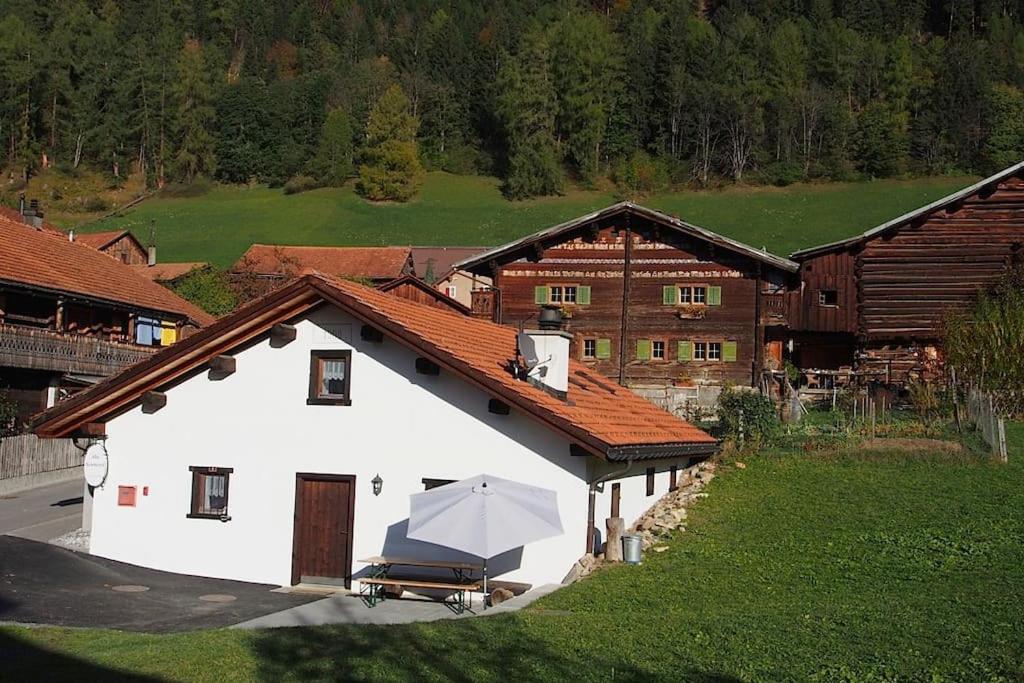 a white building with a white umbrella in front of it at Alte Sennerei in Ober-Says