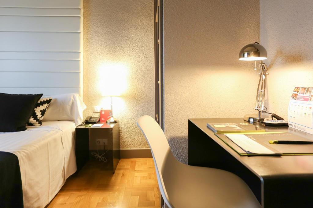 Postel nebo postele na pokoji v ubytování Habitus Hotel Leyre
