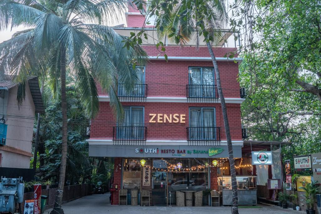 a red brick building with a store in front of it at Zense Candolim in Candolim