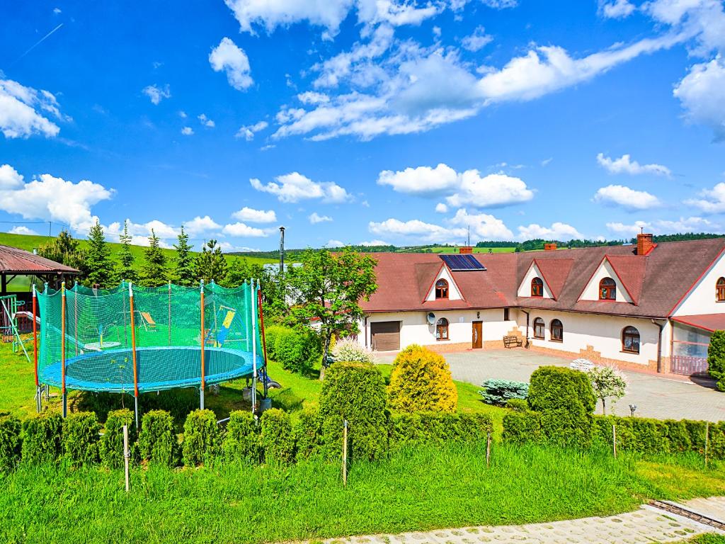 a playground in the yard of a house at Agroturystyka Pod Złotą Wiechą in Uście Gorlickie