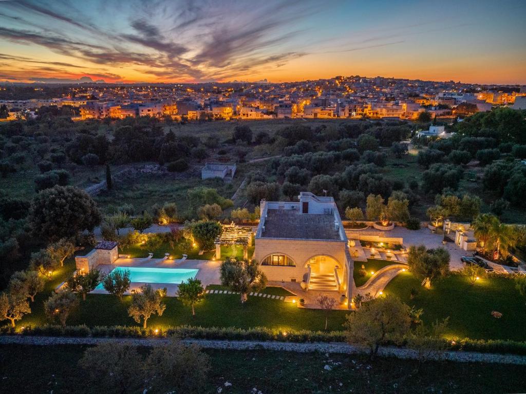une vue aérienne d'une maison avec piscine la nuit dans l'établissement Villa Icaria, à Carovigno