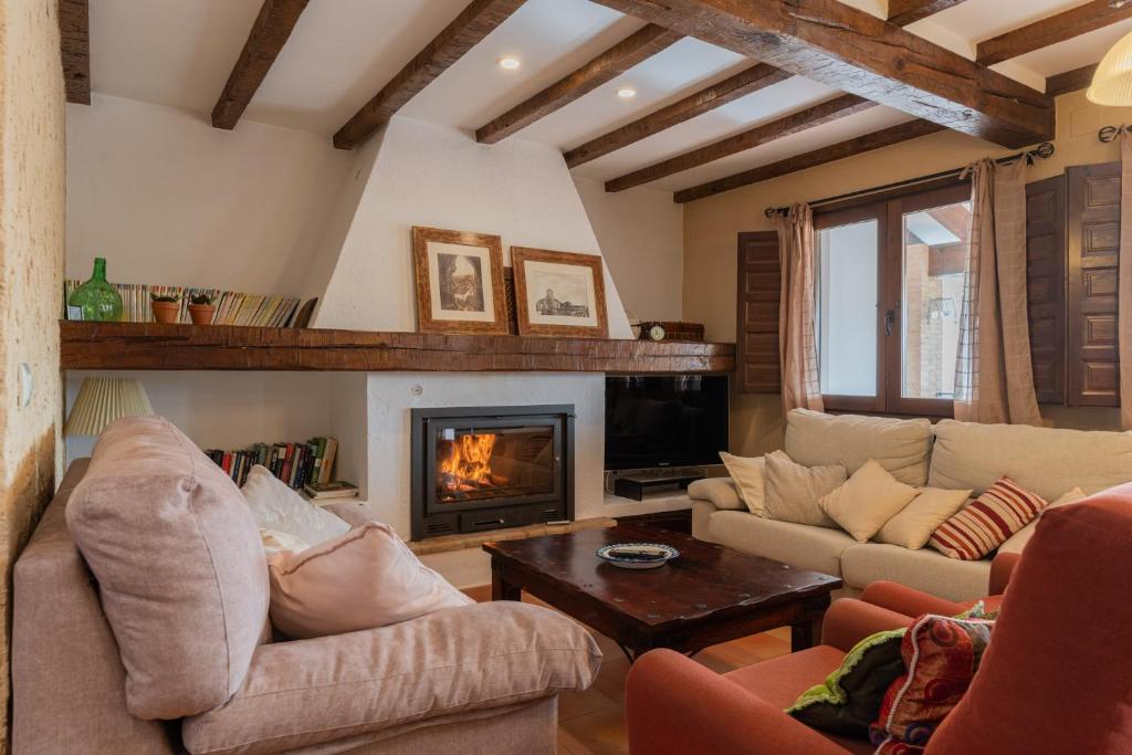 a living room with couches and a fireplace at Casa Rural El Abuelo Luis in Molinicos