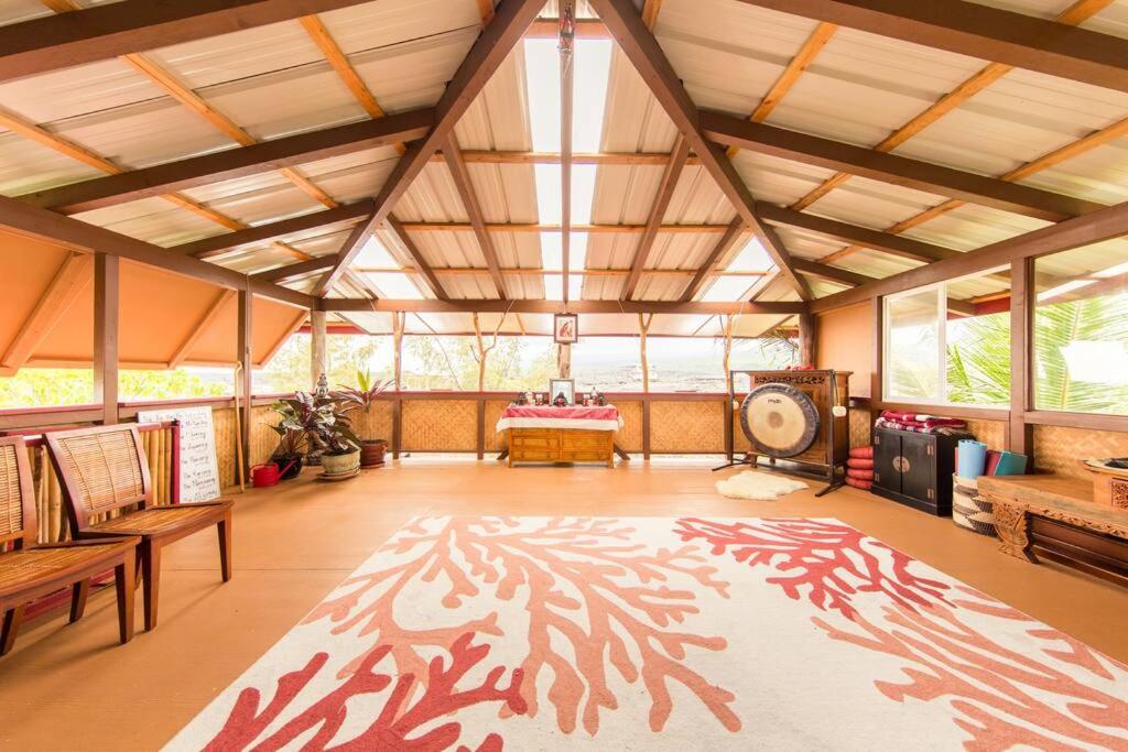 a large room with a large rug on the floor at THE MAGICAL LAVA TEMPLE with EPIC Volcano Views! in Kehena