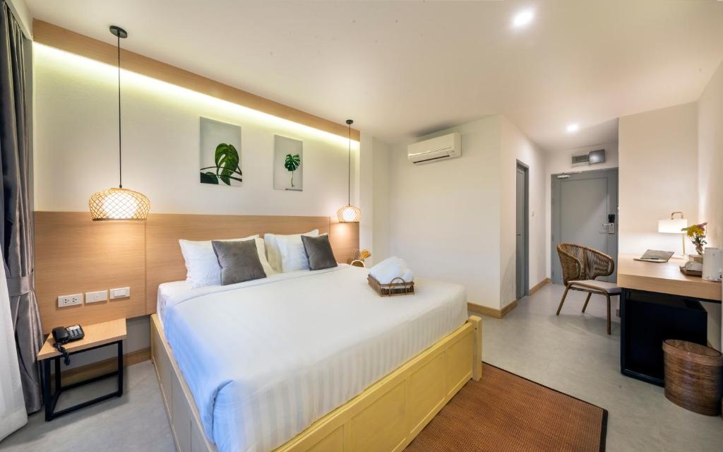 Postel nebo postele na pokoji v ubytování Ai Pai Hotel