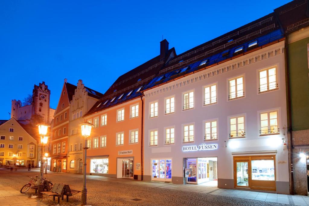 a row of buildings in a street at night at Hotel Füssen in Füssen