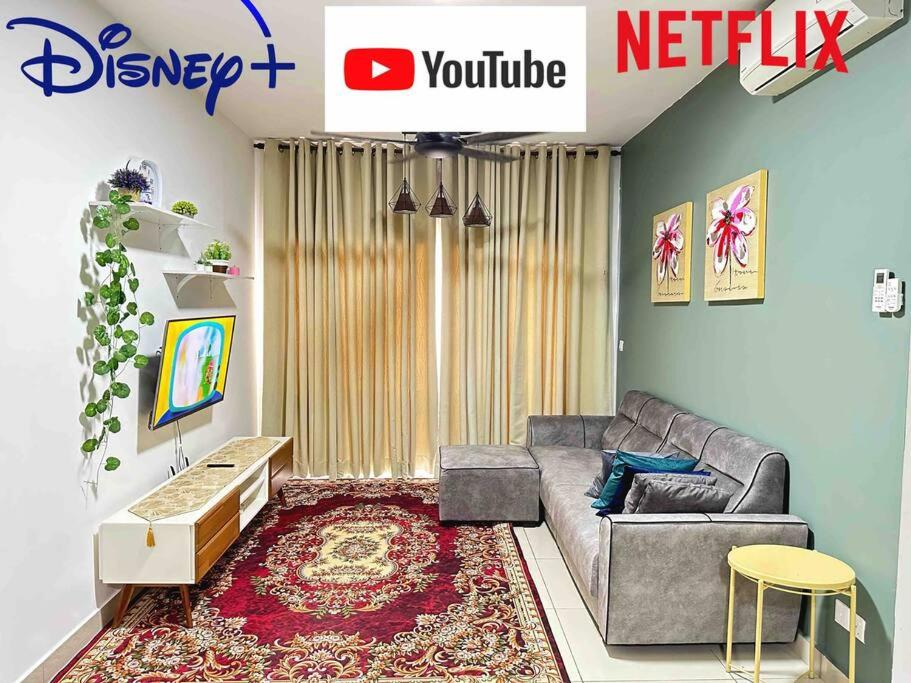 a living room with a couch and a table at The Cozy@Southville, Bangi (Netflix/Disney+/Pool) in Kampong Tangkas
