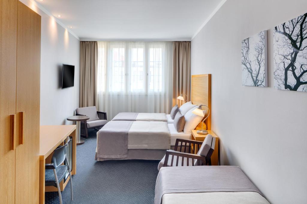 Postel nebo postele na pokoji v ubytování Hotel Clement