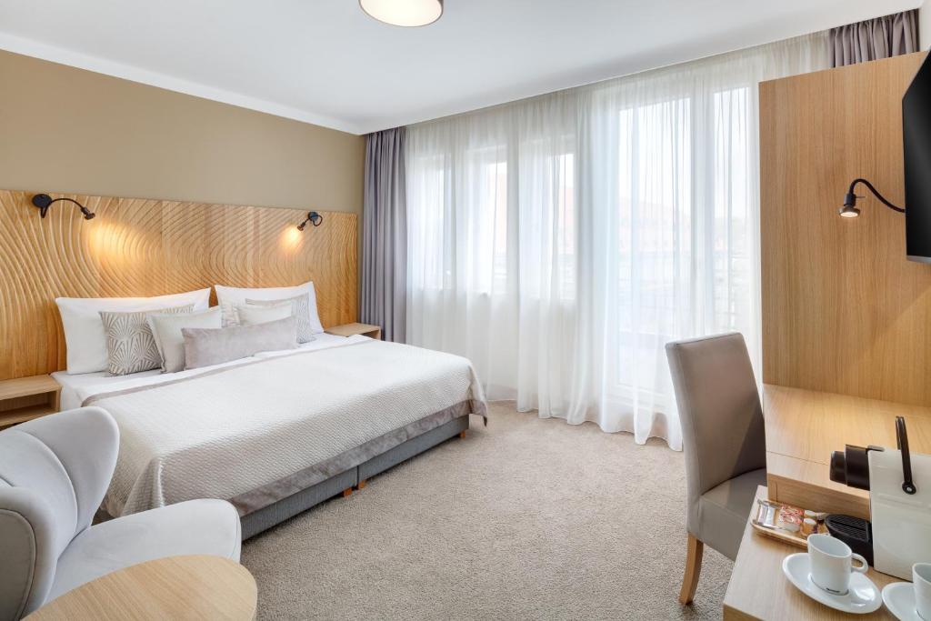 Postel nebo postele na pokoji v ubytování Hotel Clement