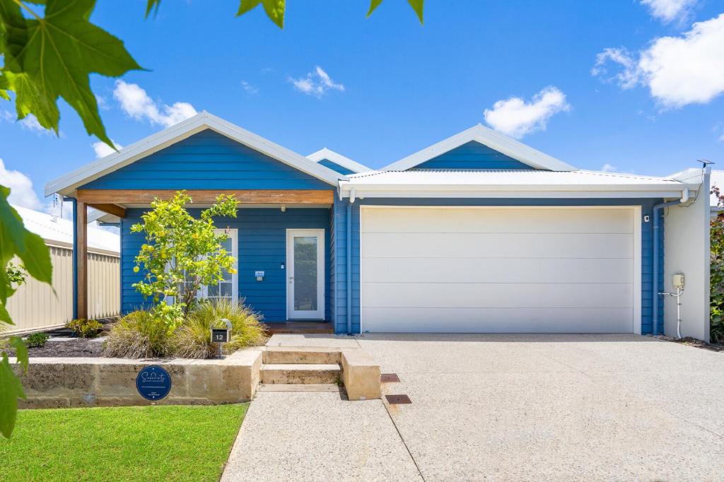 a blue house with a white garage at AZZURE on WATERVILLE in Dunsborough