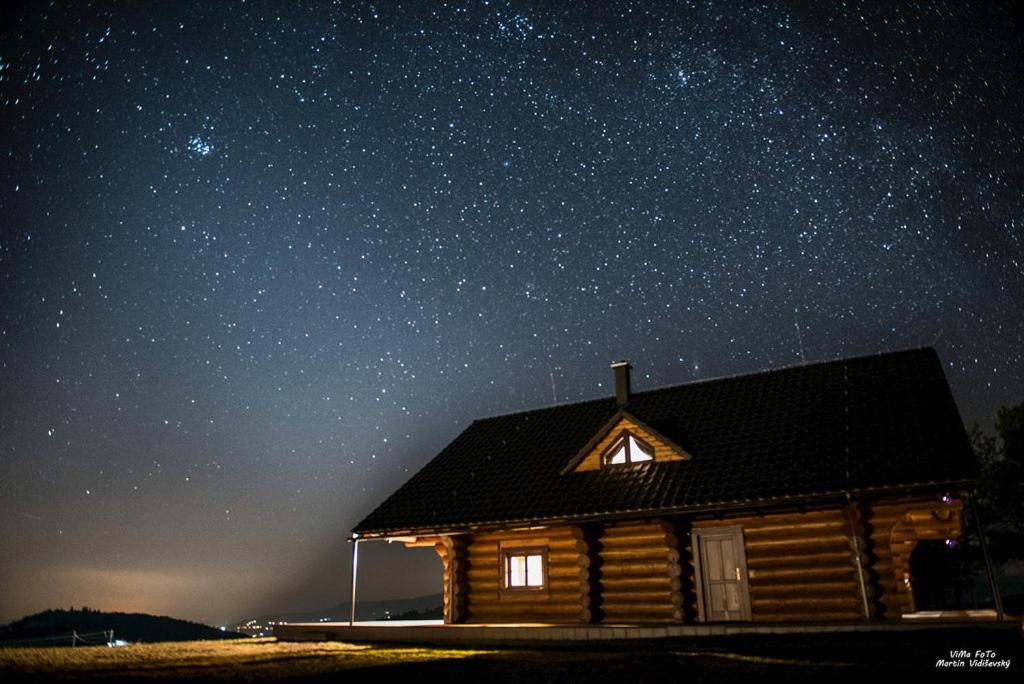 a log cabin under a starry sky at night at Zrub pod Poľanou in Detvianska Huta
