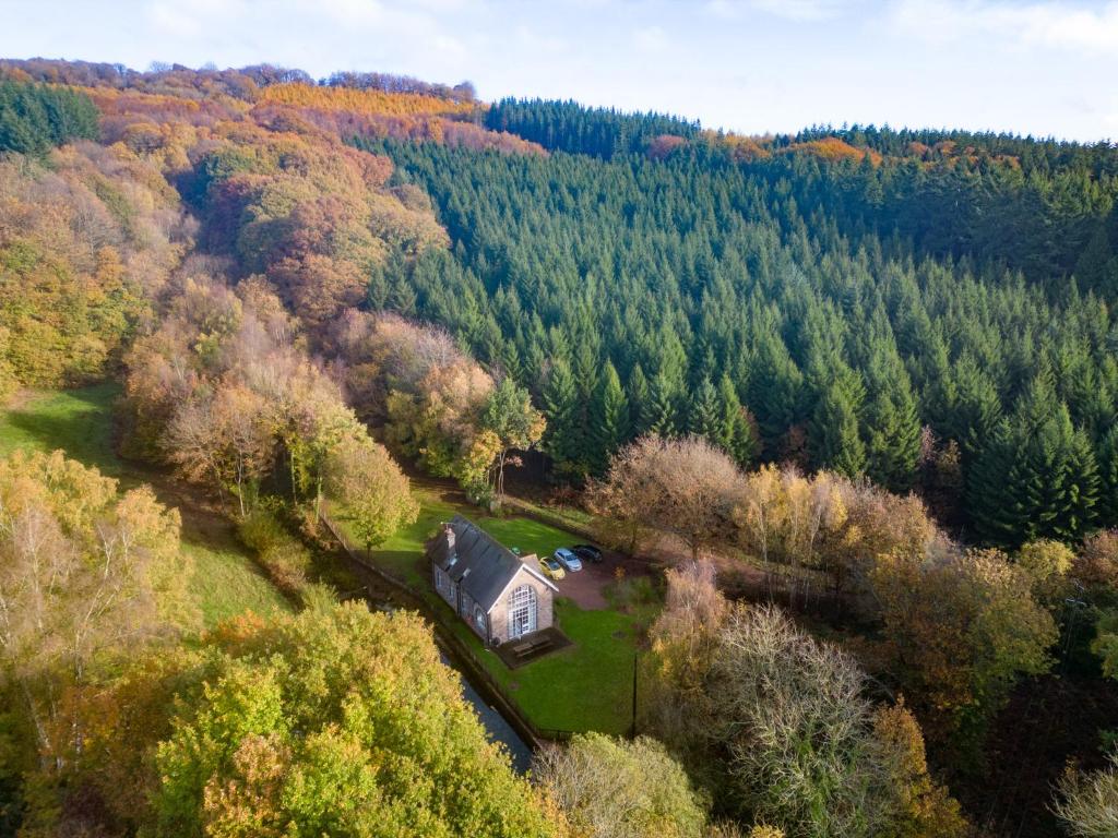 an aerial view of a house in the middle of a forest at The Old Pump House in Lydney