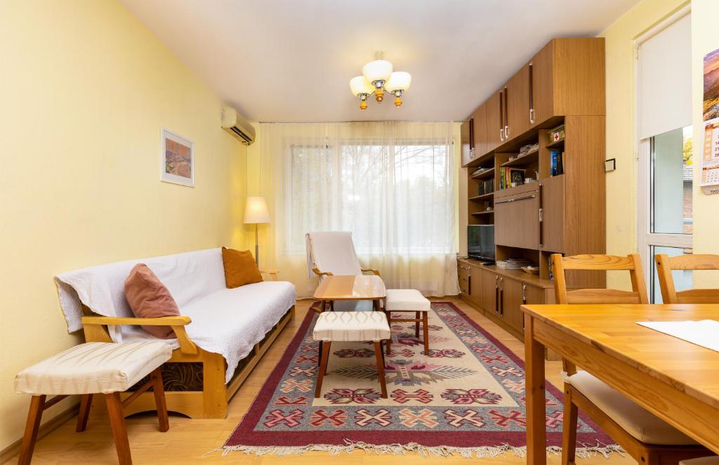 a living room with a couch and a table at Quiet apartment near the center in Plovdiv