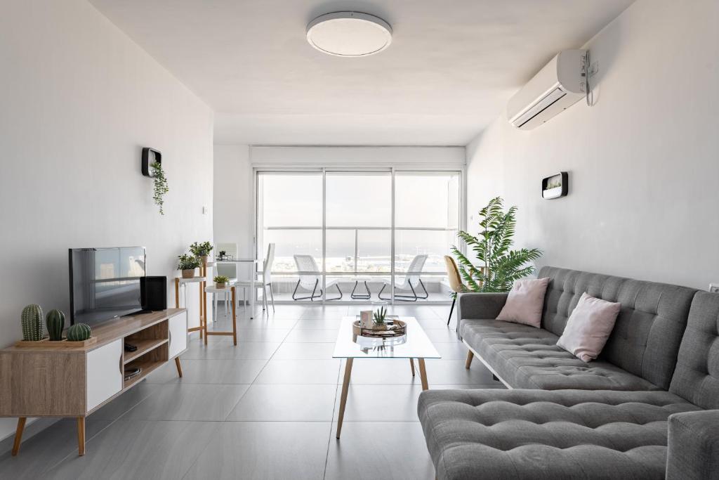 a living room with a couch and a table at Abbas BayView Apartment in Haifa