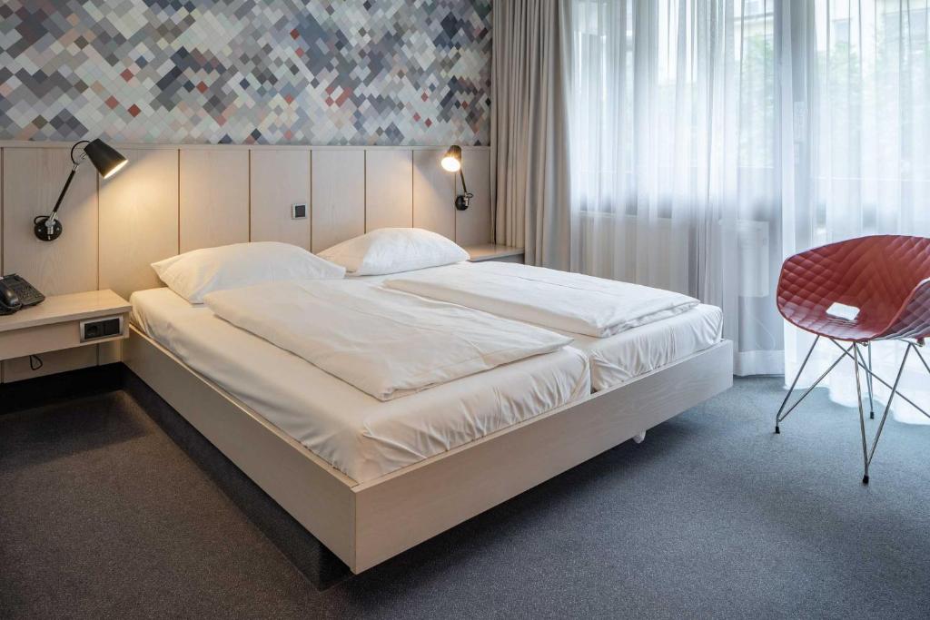Postel nebo postele na pokoji v ubytování Hotel Schiller