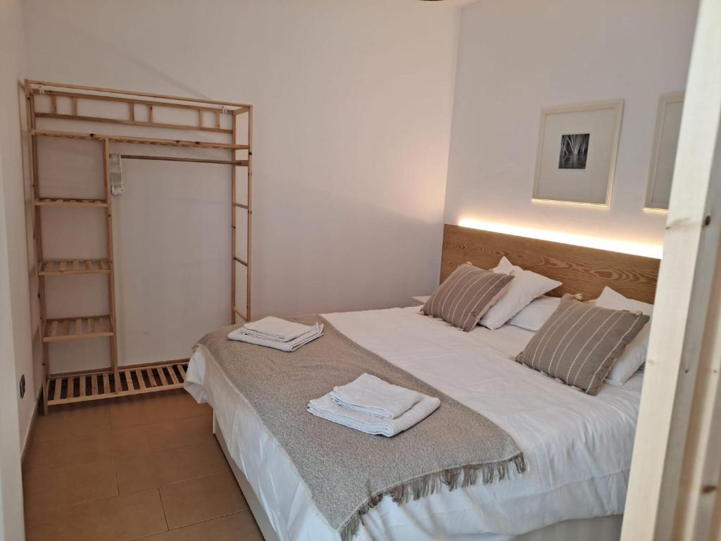 a bedroom with a large bed with towels on it at Precioso loft al lado Parc Vallparadís by Lofties in Terrassa