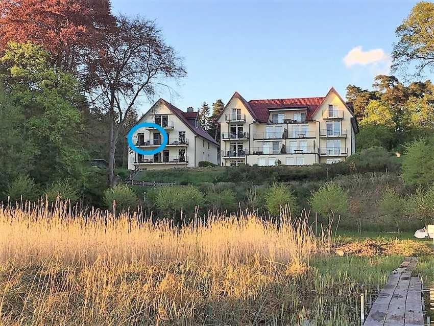 a large house sitting on top of a field at Haus am Kölpinsee App 4 4 in Kölpinsee